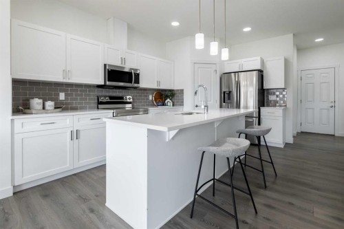 48 Heritage Manor, Cochrane, AB - Indoor Photo Showing Kitchen With Upgraded Kitchen