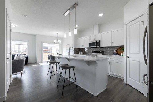 48 Heritage Manor, Cochrane, AB - Indoor Photo Showing Kitchen With Upgraded Kitchen