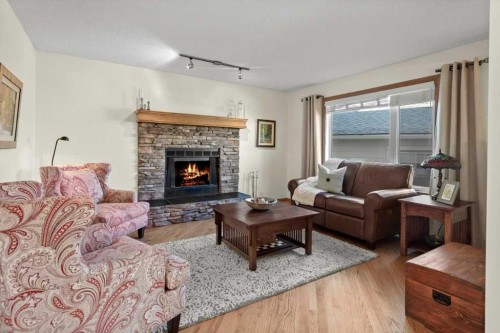 31 River Rock Manor Se, Calgary, AB - Indoor Photo Showing Living Room With Fireplace