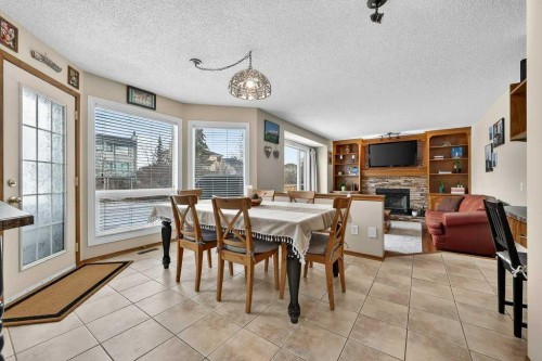 108 Hawkstone Close Nw, Calgary, AB - Indoor Photo Showing Dining Room With Fireplace