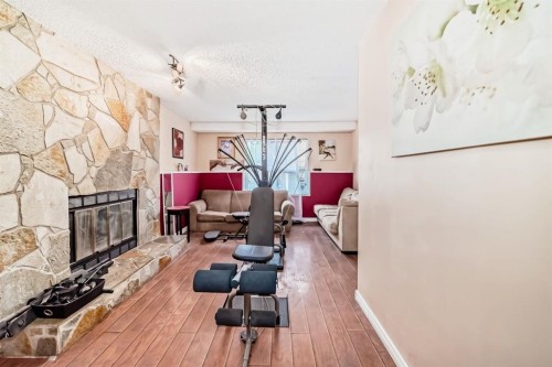 17007 Sunvale Road Se, Calgary, AB - Indoor Photo Showing Other Room With Fireplace