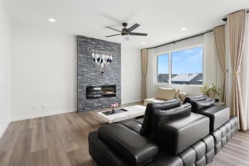 67 Royston Heath Nw, Calgary, AB - Indoor Photo Showing Living Room With Fireplace