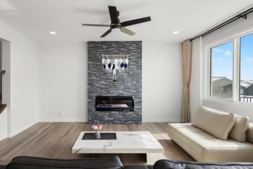 67 Royston Heath Nw, Calgary, AB - Indoor Photo Showing Living Room With Fireplace
