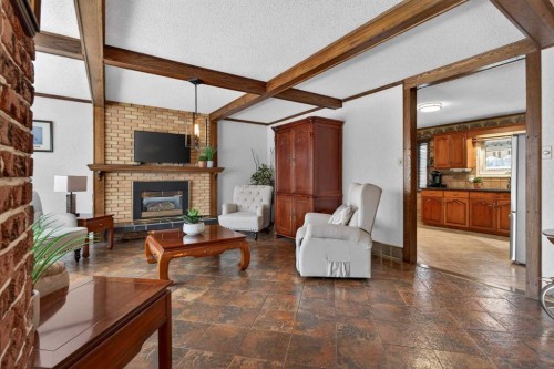19 Beaupre Crescent Nw, Calgary, AB - Indoor Photo Showing Living Room With Fireplace