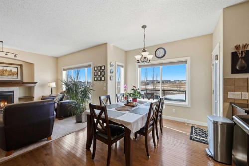 212 Springmere Road, Chestermere, AB - Indoor Photo Showing Dining Room With Fireplace