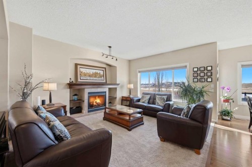 212 Springmere Road, Chestermere, AB - Indoor Photo Showing Living Room With Fireplace