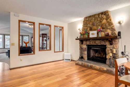 76 Sunmount Road Se, Calgary, AB - Indoor Photo Showing Living Room With Fireplace