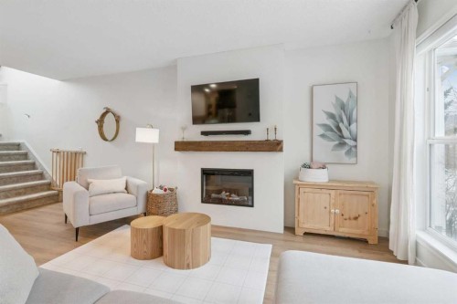 46 Prestwick Rise Se, Calgary, AB - Indoor Photo Showing Living Room With Fireplace