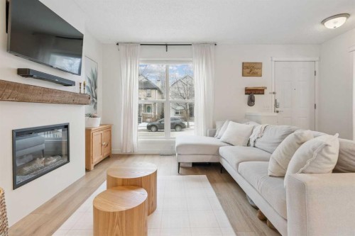 46 Prestwick Rise Se, Calgary, AB - Indoor Photo Showing Living Room With Fireplace