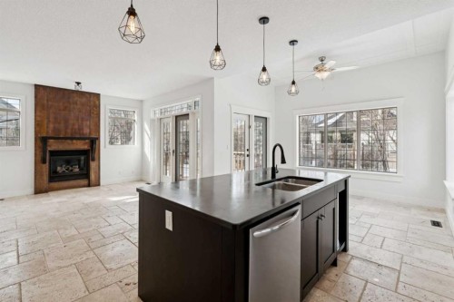 1 Discovery Ridge Link Sw, Calgary, AB - Indoor Photo Showing Kitchen With Fireplace With Double Sink