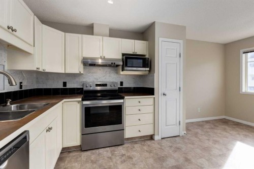 79 Copperfield Court Se, Calgary, AB - Indoor Photo Showing Kitchen With Double Sink
