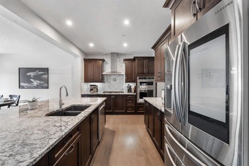 308 Lucas Way Nw, Calgary, AB - Indoor Photo Showing Kitchen With Stainless Steel Kitchen With Double Sink With Upgraded Kitchen