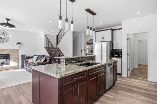 30 Ranchers Crescent, Okotoks, AB - Indoor Photo Showing Kitchen With Fireplace With Double Sink With Upgraded Kitchen