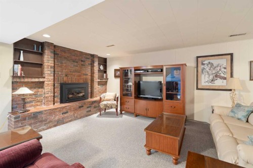 59 Hogarth Crescent Sw, Calgary, AB - Indoor Photo Showing Living Room With Fireplace