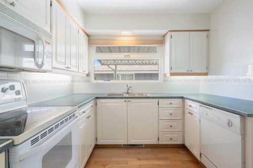 59 Hogarth Crescent Sw, Calgary, AB - Indoor Photo Showing Kitchen With Double Sink