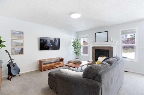 54 Springborough Point Sw, Calgary, AB - Indoor Photo Showing Living Room With Fireplace