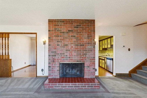 7223 Bow Crescent Nw, Calgary, AB - Indoor Photo Showing Living Room With Fireplace