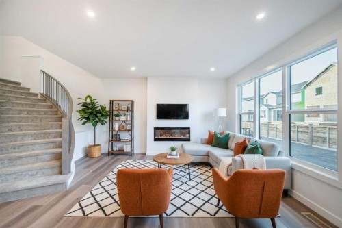 73 Royston Grove Nw, Calgary, AB - Indoor Photo Showing Living Room With Fireplace