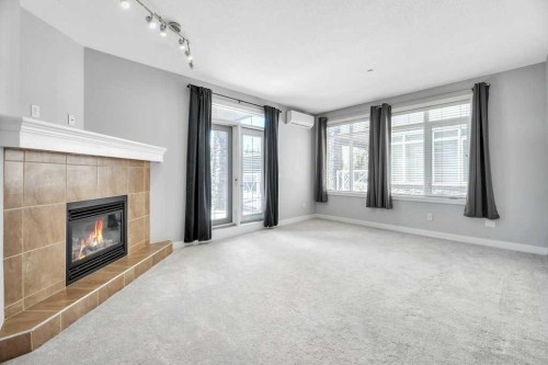 102-1005B Westmount Drive, Strathmore, AB - Indoor With Fireplace
