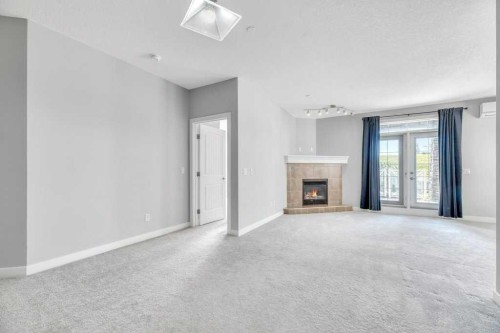 102-1005B Westmount Drive, Strathmore, AB - Indoor Photo Showing Living Room With Fireplace