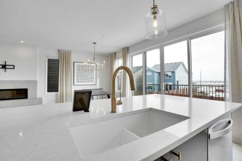 195 Lucas Common Nw, Calgary, AB - Indoor Photo Showing Kitchen With Fireplace