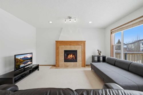125 Panamount Heath Nw, Calgary, AB - Indoor Photo Showing Living Room With Fireplace