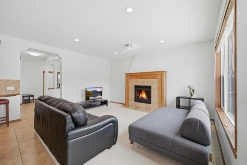 125 Panamount Heath Nw, Calgary, AB - Indoor Photo Showing Living Room With Fireplace