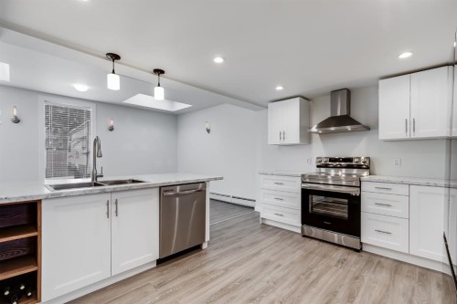 11 Foley Road Se, Calgary, AB - Indoor Photo Showing Kitchen With Double Sink