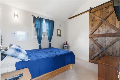 212 Cottageclub Crescent, Rural Rocky View County, AB - Indoor Photo Showing Bedroom