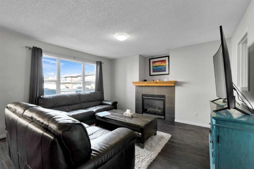 2 Saddleland Way Ne, Calgary, AB - Indoor Photo Showing Living Room With Fireplace