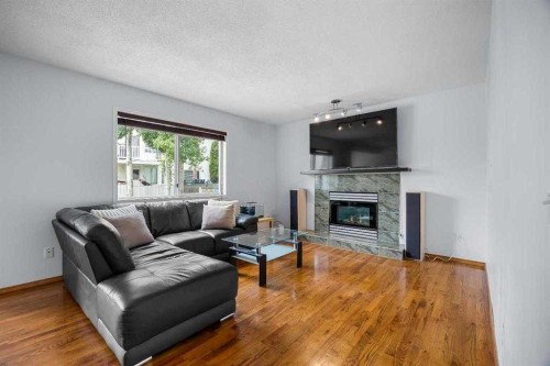 240 Arbour Ridge Way Nw, Calgary, AB - Indoor Photo Showing Living Room With Fireplace