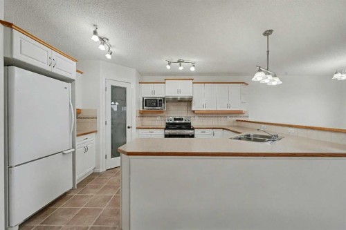 12 Tarawood Grove Ne, Calgary, AB - Indoor Photo Showing Kitchen With Double Sink