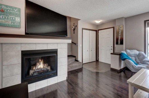58 Elgin Meadows Gardens Se, Calgary, AB - Indoor Photo Showing Living Room With Fireplace
