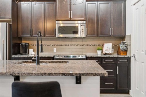 339 Fireside Place, Cochrane, AB - Indoor Photo Showing Kitchen With Upgraded Kitchen