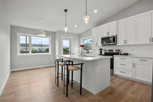335 Sheep River Place, Okotoks, AB - Indoor Photo Showing Kitchen With Upgraded Kitchen