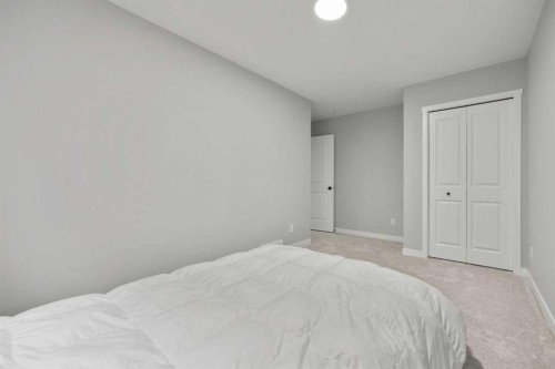335 Sheep River Place, Okotoks, AB - Indoor Photo Showing Bedroom