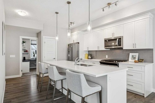 718 Cranbrook Walk Se, Calgary, AB - Indoor Photo Showing Kitchen With Stainless Steel Kitchen With Double Sink With Upgraded Kitchen