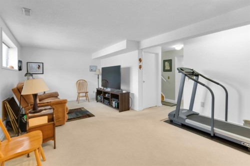 15 Coach Manor Rise Sw, Calgary, AB - Indoor Photo Showing Gym Room