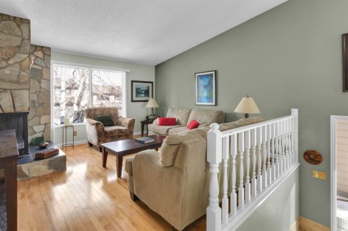 15 Coach Manor Rise Sw, Calgary, AB - Indoor Photo Showing Living Room With Fireplace