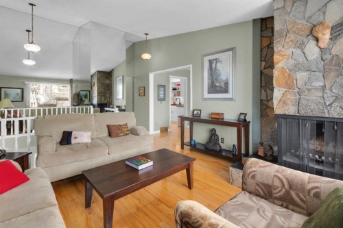 15 Coach Manor Rise Sw, Calgary, AB - Indoor Photo Showing Living Room With Fireplace