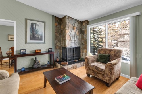 15 Coach Manor Rise Sw, Calgary, AB - Indoor Photo Showing Living Room With Fireplace