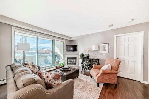 306-1121 6 Avenue Sw, Calgary, AB - Indoor Photo Showing Living Room With Fireplace