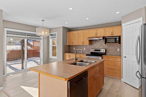 138 Saddlecrest Park Ne, Calgary, AB - Indoor Photo Showing Kitchen With Stainless Steel Kitchen With Double Sink