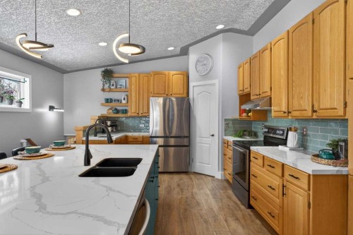 64 Foxwell Road Se, Calgary, AB - Indoor Photo Showing Kitchen With Stainless Steel Kitchen With Double Sink