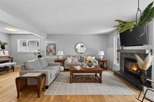 64 Foxwell Road Se, Calgary, AB - Indoor Photo Showing Living Room With Fireplace