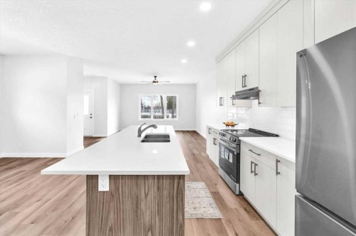 1014 Limit Avenue, Crossfield, AB - Indoor Photo Showing Kitchen With Stainless Steel Kitchen With Double Sink With Upgraded Kitchen