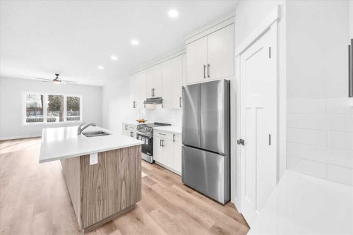1014 Limit Avenue, Crossfield, AB - Indoor Photo Showing Kitchen With Stainless Steel Kitchen With Double Sink