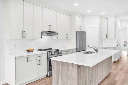 1014 Limit Avenue, Crossfield, AB - Indoor Photo Showing Kitchen With Double Sink With Upgraded Kitchen