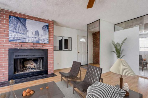 55 Queen Isabella Close Se, Calgary, AB - Indoor Photo Showing Living Room With Fireplace