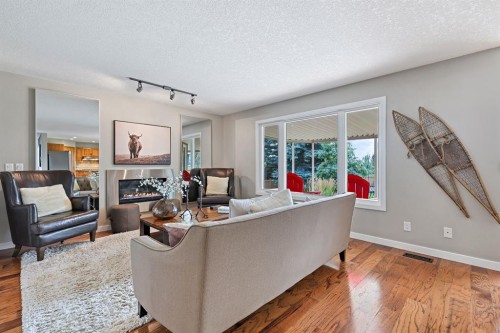 33 Sunset Crescent, Okotoks, AB - Indoor Photo Showing Living Room With Fireplace